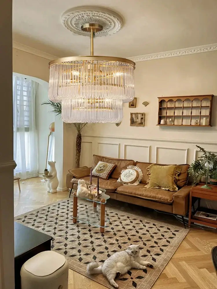 A gold-toned minimalist decorbites brass glass bar chandelier with cascading crystal strands for living room lighting