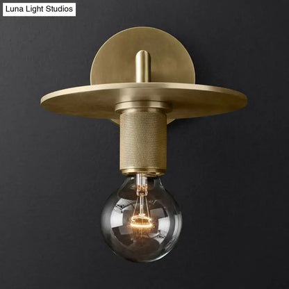 DecorBites minimalist bronze wall sconce with brass finish, textured cylindrical stem, exposed light bulb, and glass shade options