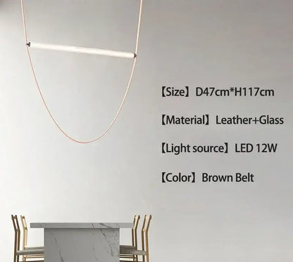 Minimalist brown leather hanging clothes drying rack with a sleek copper pendant lamp and white glass element decorbites belt pendant light