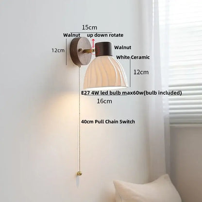 Minimalist ceramic walnut wood wall light featuring a walnut finish with white ceramic ribbed shade and brass pull chain switch