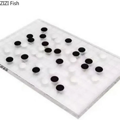 Minimalist clear geometric chess set with black and white circular pieces on acrylic board for elegant decorbites decor