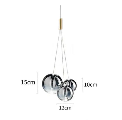 Modern chrome finished glass bubble led pendant light with brass accent and thin cables for dining room decorbites glass bubble
