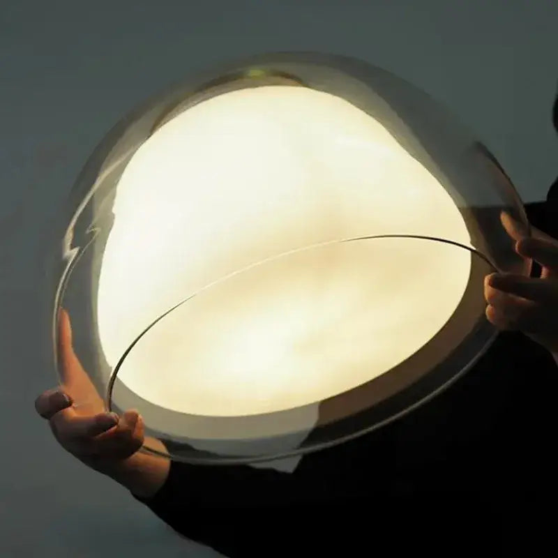 Minimalist clear glass jelly pendant lamp with translucent dome and warm glow for living room lighting
