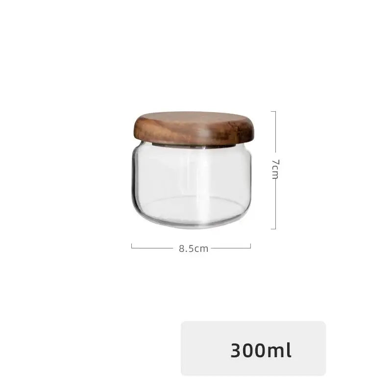 Minimalist clear glass storage jar with smooth rounded acacia wood lid for kitchen organization