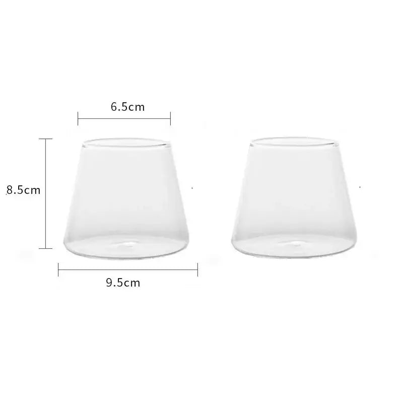 Minimalist clear glass water cup with tapered wide base and narrow rim for kitchen and dining room use