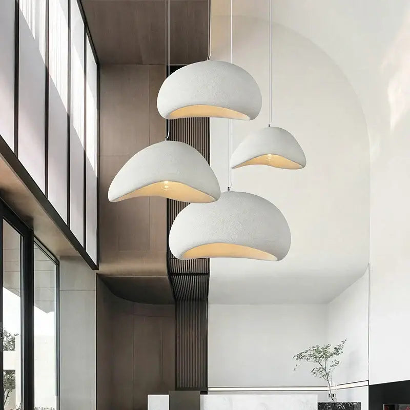 Modern white ceramic decorbites cobblestone pendant lights with textured dome shape and warm interior glow for dining room
