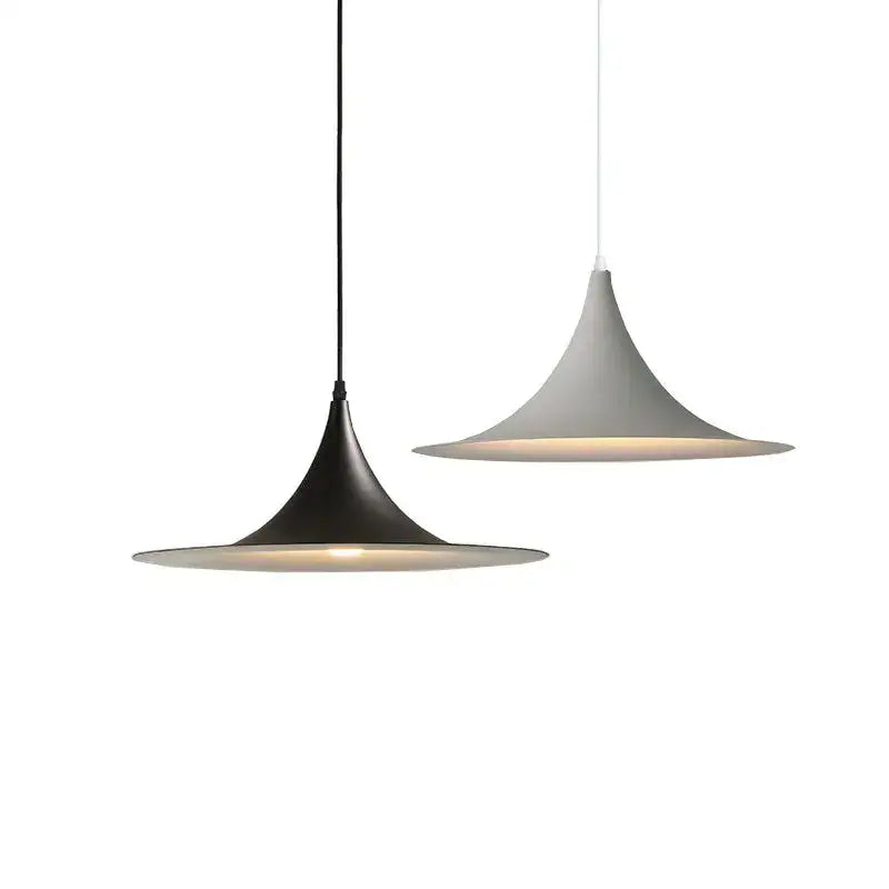 Two modern pendant lights with black and white matte shades hang as a minimalist decorbites horn chandelier pendant