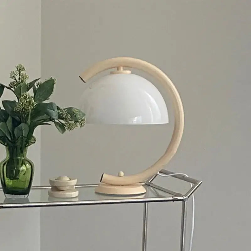 Minimalist cream bauhous mushroom table lamp with curved wooden frame and smooth white glass dome for bedroom use