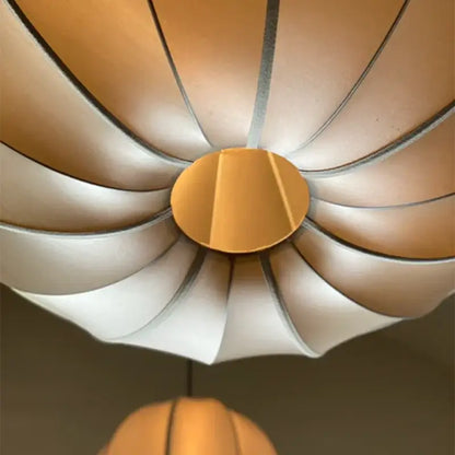 A modern petal-shaped pendant light with a warm beige and white gradient finish for dining room decorbites danish pendant