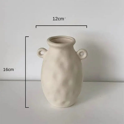 Minimalist cream ceramic art vase with textured surface and looped handles by decorbites ceramic perfect for living room decor