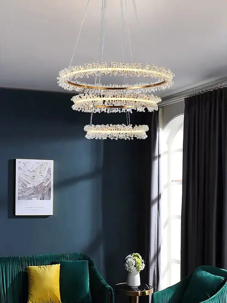 A modern multi-tiered gold black ring chandelier with crystal gold black droplets for dining room decorbites lighting