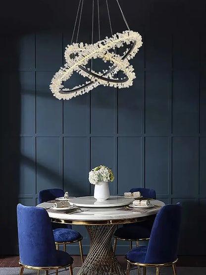 A modern minimalist crystal gold black ring chandelier with interlocking rings and sparkling clear crystals for dining room decorbites