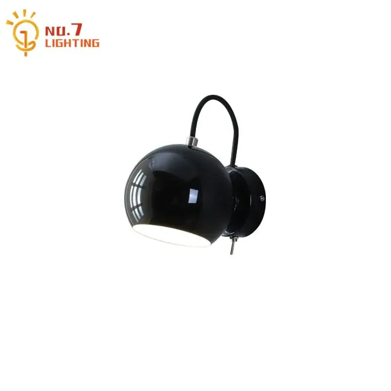 Black spherical wall lamp with curved arm and metallic plate in minimalist decorbites cream wind led bedroom design
