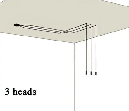 Three black cylindrical heads of decorbites industrial retro wall lamp suspended by thin wires for kitchen lighting
