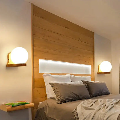 Warm-toned wooden wall lamp with integrated led lighting strip and frosted glass spherical lamps for bedroom use