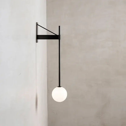 Minimalist geometric iron wall lamp featuring a black metal frame and spherical frosted glass globe for bedroom decorbites wall lamp