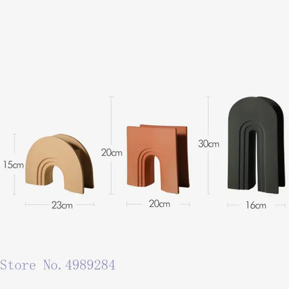 Three minimalist arched bookends in matte gold terracotta and black finishes for decorbites geometric stripes ceramic decor