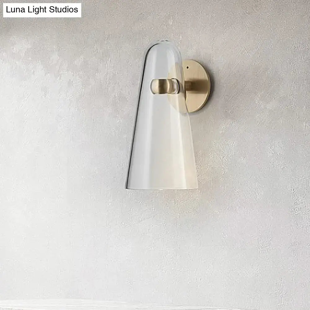 Minimalist wall mount lighting with a translucent white glass shade and brushed brass hardware for kitchen use