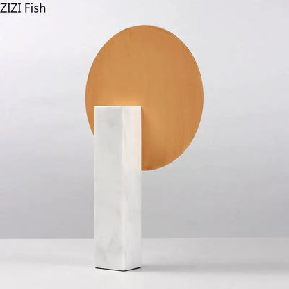 Minimalist gold geometric windmill desk decoration with a warm-toned wooden disc on a white marble base