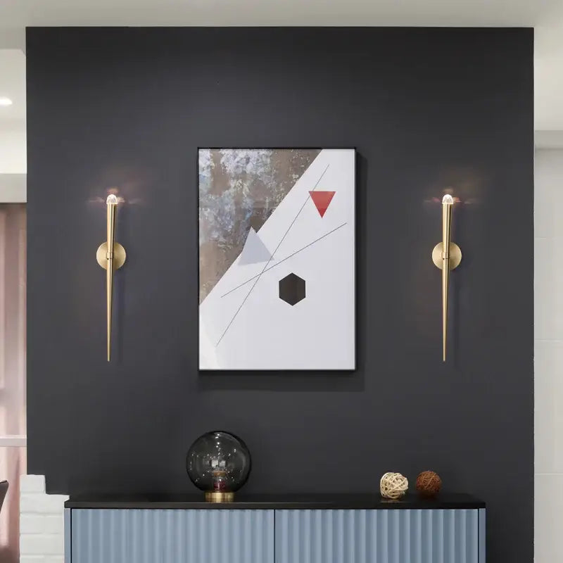 Minimalist gold crystal wall sconce with slender tapered design flanks modern abstract painting decorbites crystal minimalist