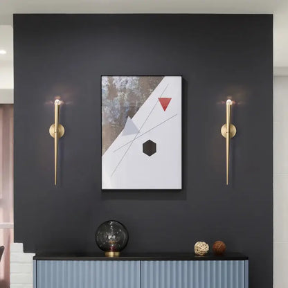 Minimalist gold crystal wall sconce with slender tapered design flanks modern abstract painting decorbites crystal minimalist