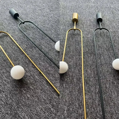Minimalist gold pendant lights with double head glass ball design and sleek u-shaped metal frame for bedroom