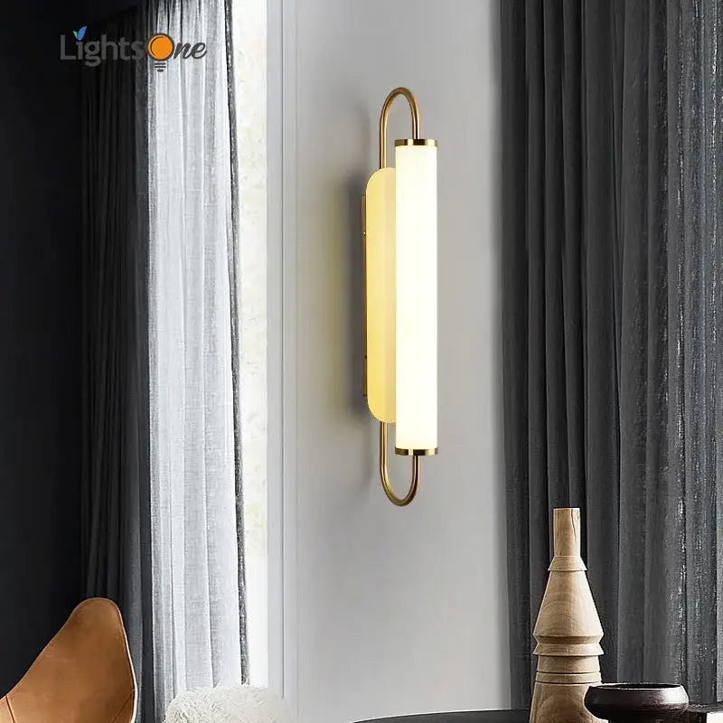 Minimalist gold elegant wall sconce with a sleek curved metal frame and frosted glass diffuser for bedroom decorbites elegant wall
