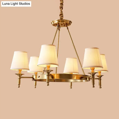 Brass-finished minimalist conical ceiling chandelier with six cream fabric bedroom shades for elegant lighting