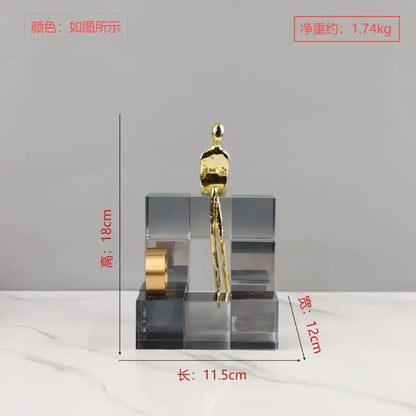 A sleek minimalist gold figurine on transparent geometric stair crystal blocks for living room decorbites decor