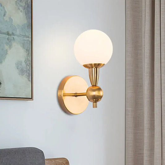 Minimalist gold wall sconce with hand blown frosted glass globe shade for elegant bedroom sconce light