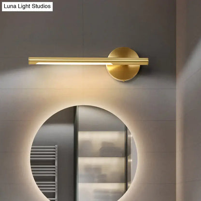 Minimalist gold wall light with acrylic diffuser featuring a modern cylindrical bar and circular base for bedroom use