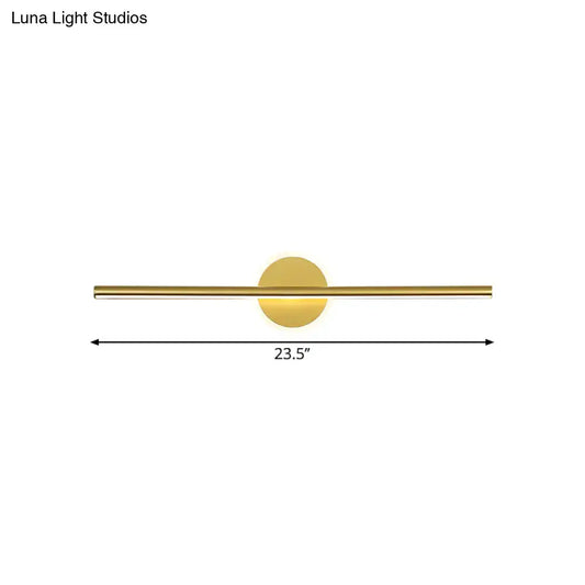 Minimalist gold linear led wall sconce with a gold-toned sleek horizontal bar and circular light fixture modern wall sconce