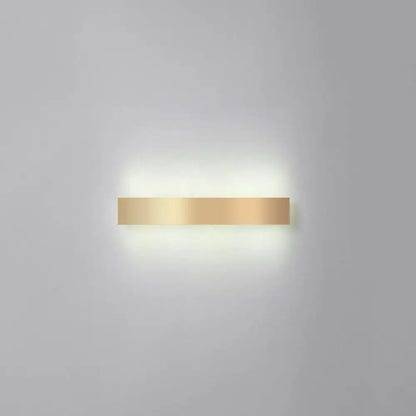A sleek minimalist gold plated led wall sconce with a rectangular metallic finish for living room or bar lighting