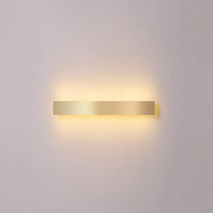 A sleek rectangular minimalist gold plated led wall sconce ideal for living room or bar lighting