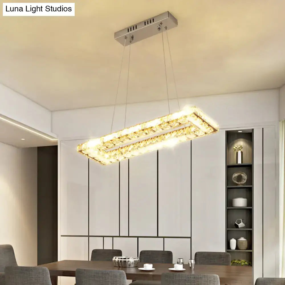 DecorBites minimalist rectangular led island pendant light with silver frame and clear K9 crystal accents emitting warm light