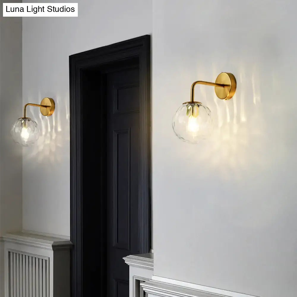 Gold-finished wall lamp with rippled clear glass sphere and faceted globe, DecorBites minimalist lighting fixture inches wide