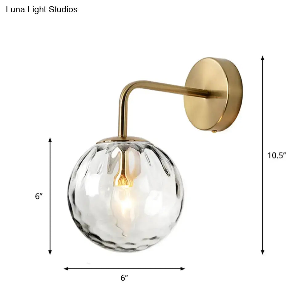 DecorBites™ minimalist wall lamp with a rippled glass sphere and warm brass finish on metal arm and mounting plate