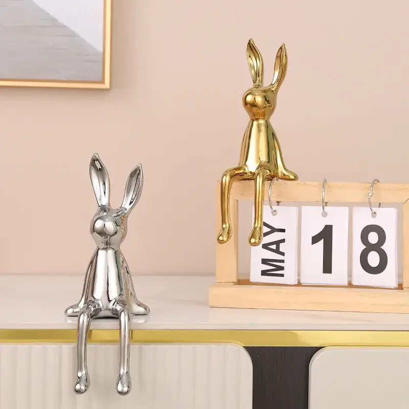 A sleek metallic gold rabbit ceramic ornament with polished finish on wooden calendar decorbites gold rabbit