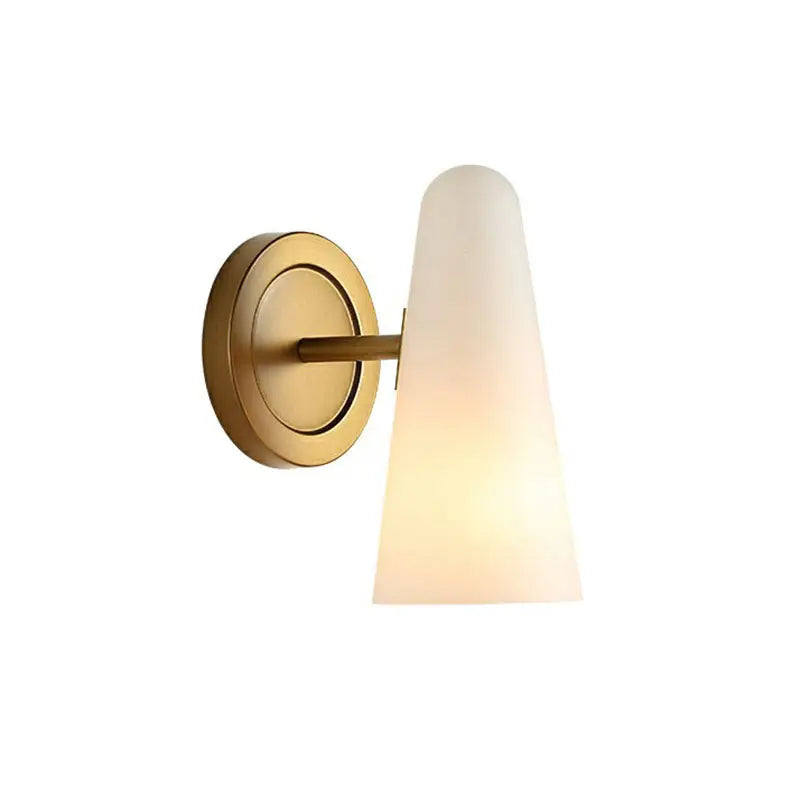 A sleek minimalist gold wall sconce light with a frosted glass shade for living room decor