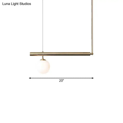 Minimalist brass pendant light with a spherical frosted glass bulb for dining room by DecorBites golden glass shade
