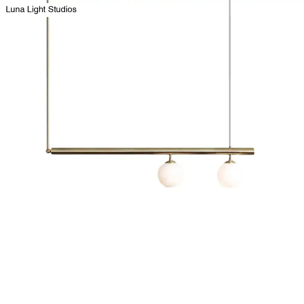 Minimalist brass DecorBites™ golden glass shade hanging lamp with two white glass bulbs for dining room lighting