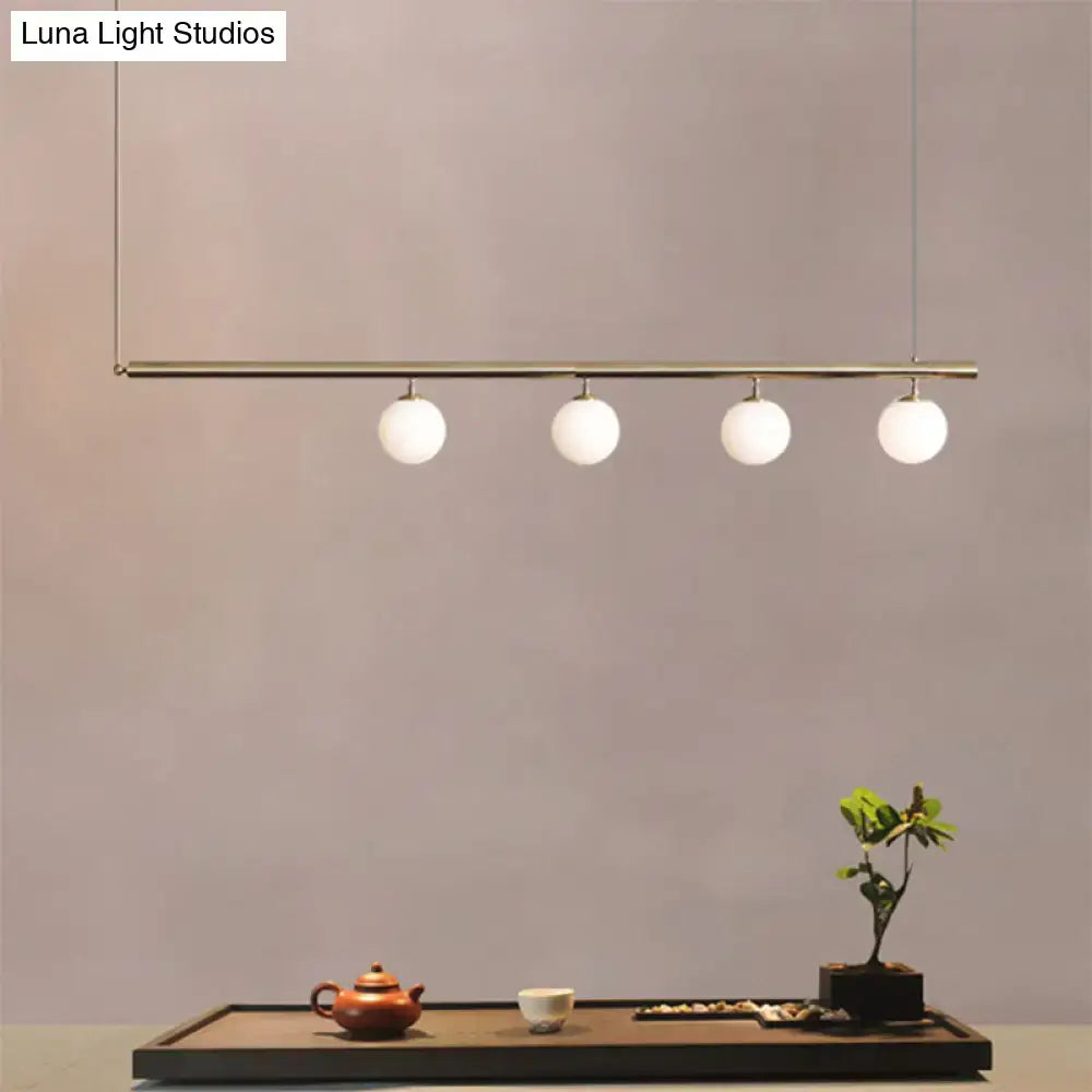 DecorBites™ modern minimalist pendant light with brass bar and frosted glass globes for dining room lighting