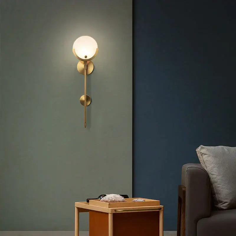 Minimalist golden marble wall lamp with gold-toned sconce, frosted glass globe, and circular accents for bedroom decorbites golden marble