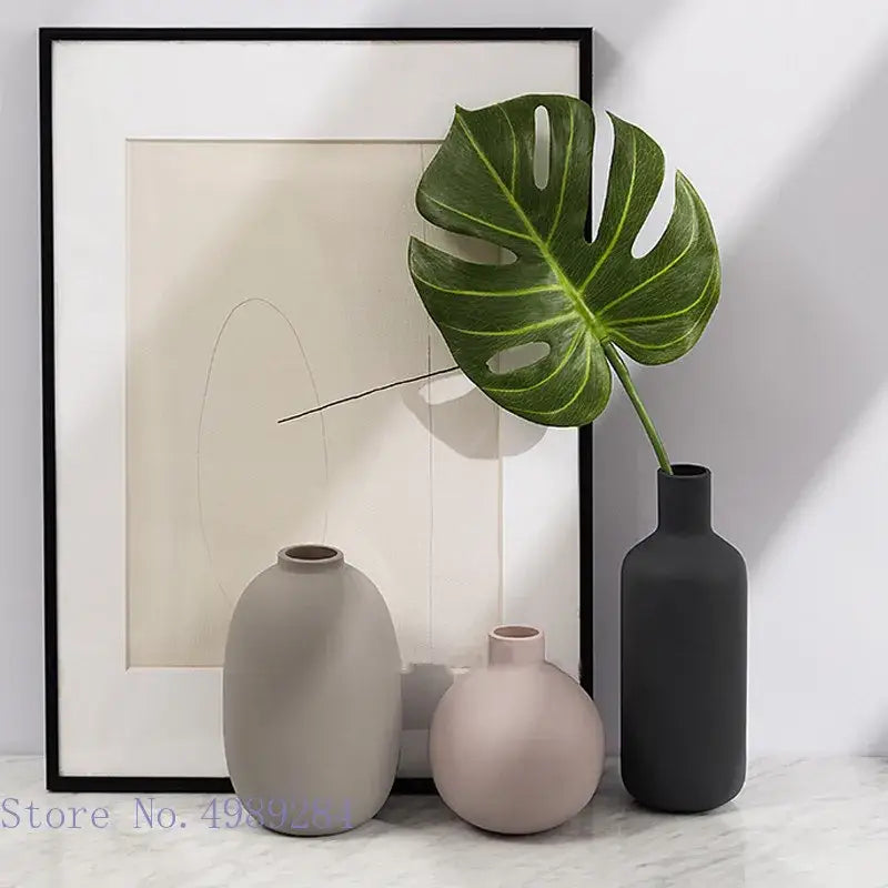 Three minimalist colorful ceramic vases in gray pink and charcoal by decorbites for elegant living room decor