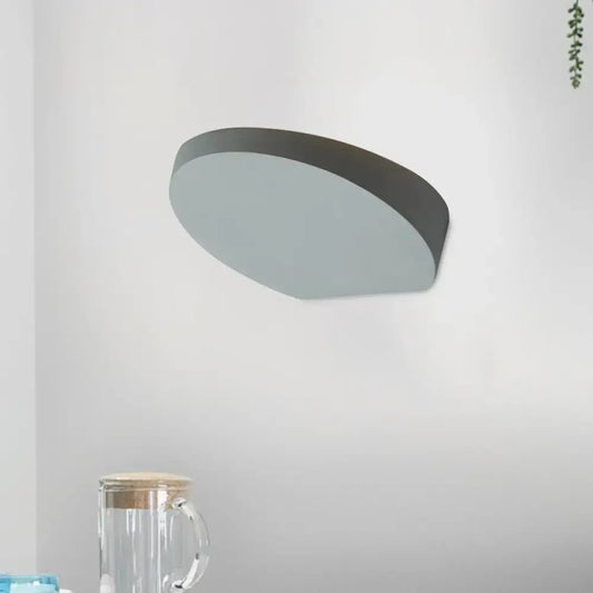 Minimalist led oval wall sconce in grey aluminum with matte finish and sleek design featuring a light bulb for corridors