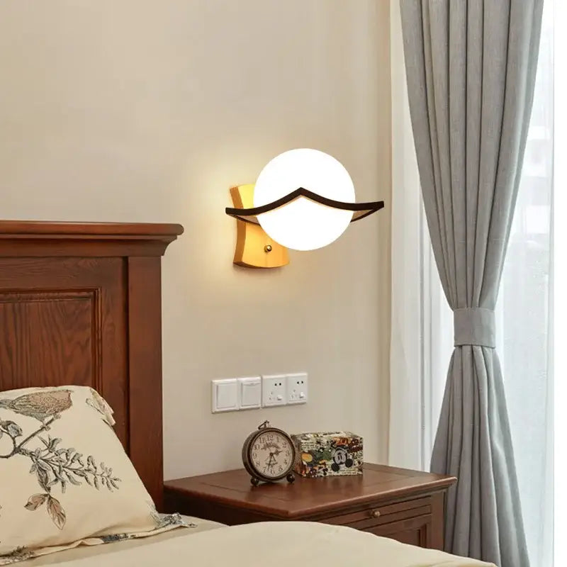 Minimalist led wooden wall lamp with round white glass globe black metal accent on warm wood base by decorbites wall lamps