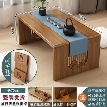 A minimalist light brown bamboo folding table with blue runner and wave carvings for bedroom tea use