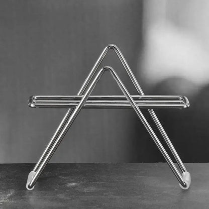 Minimalist shiny chrome triangular coffee filter holder with rounded edges and white rubber feet for kitchen use