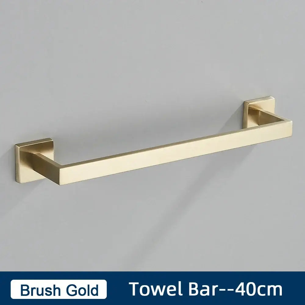 Brush gold towel bar with square mounting plates in a minimalist matte black stainless steel bathroom accessories set