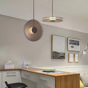 Modern minimalist glass pendant light with matte metal shade and warm led illumination for dining room